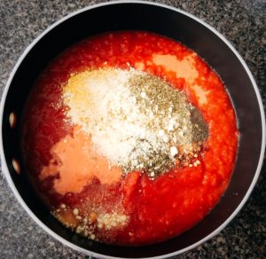 easy tomato parmesan soup and spices in a pan