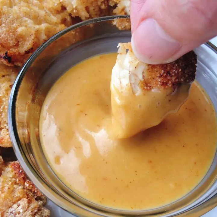 Chicken being dipped into Copycat Chick-fil-a Sauce