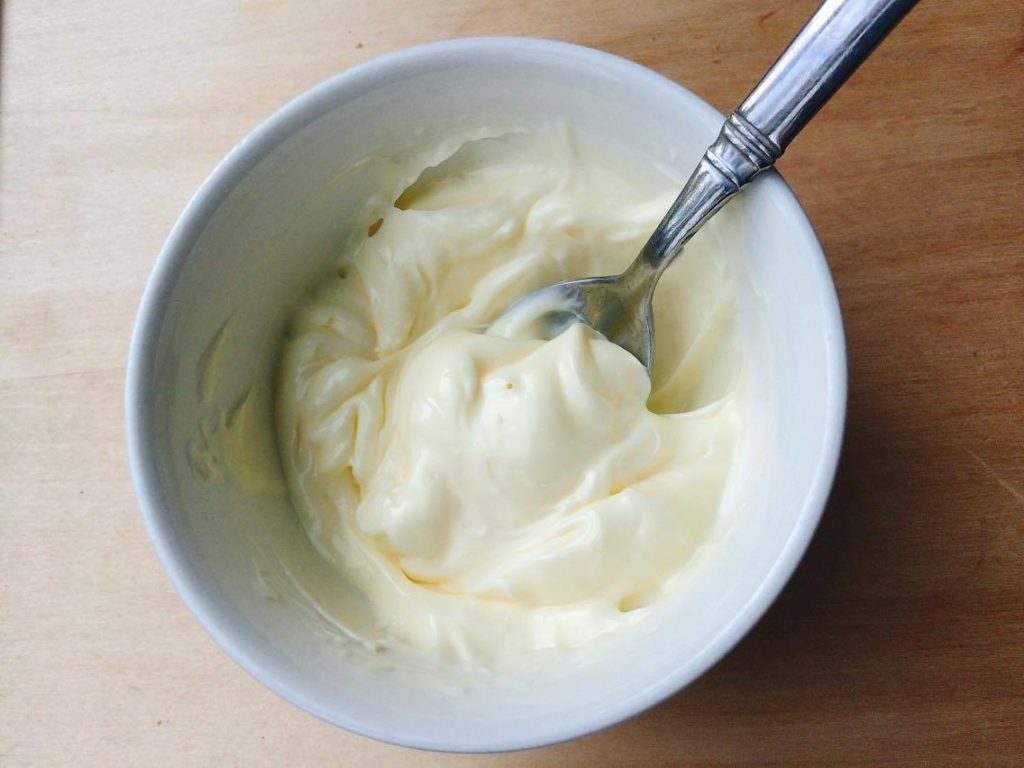 Step one mixing mayonnaise in a bowl with a spoon.