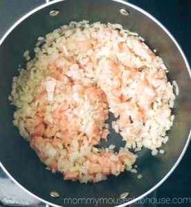 Diced chicken and onions in soup pot for Enchilada Soup