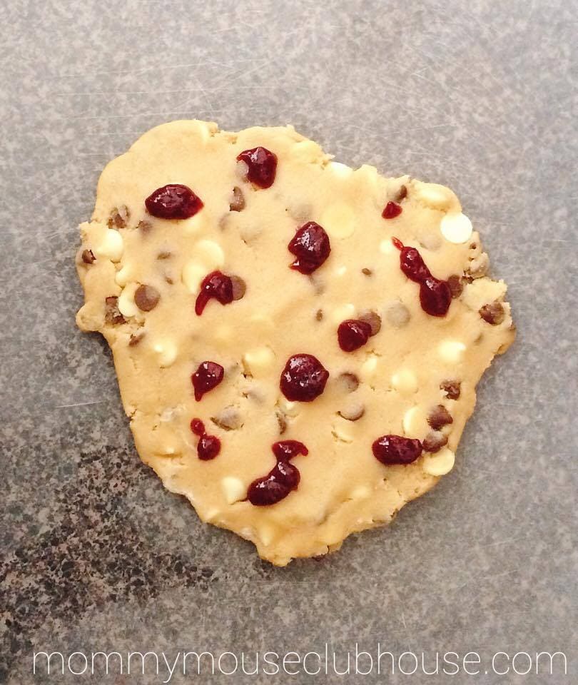 Rolled out cookie dough with dots of raspberry jam to make Disneyland's Raspberry White Chocolate Chip Cookies
