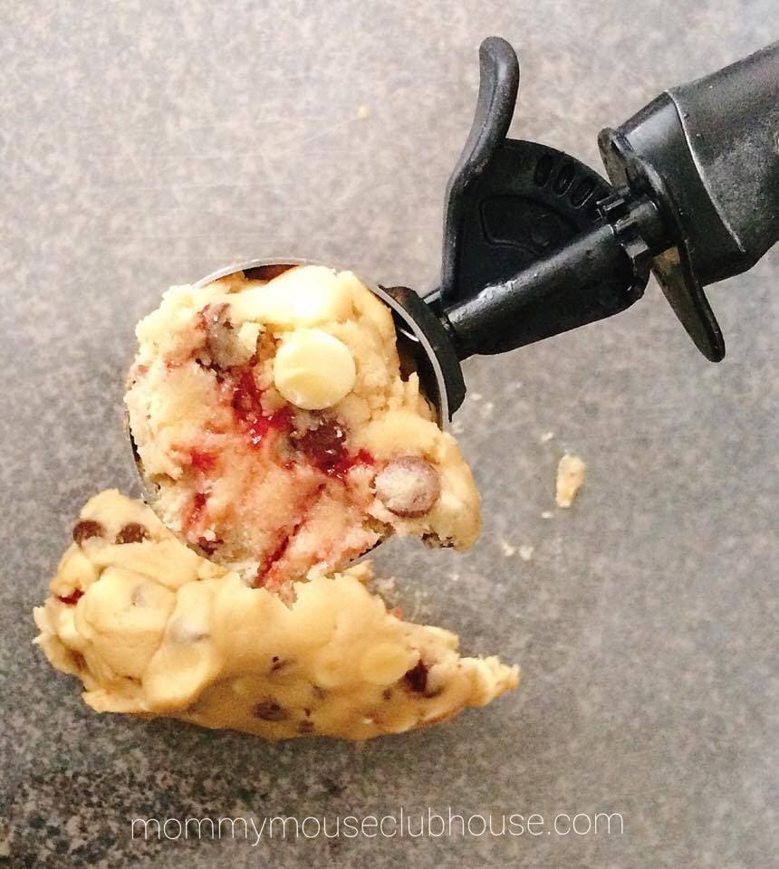 Cookie dough in a cookie scoop to make Disneyland's Raspberry White Chocolate Chip Cookies