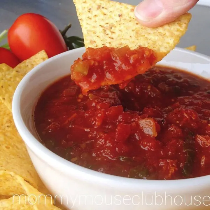 A tortilla chip dipped in Homemade Restaurant Style Salsa.