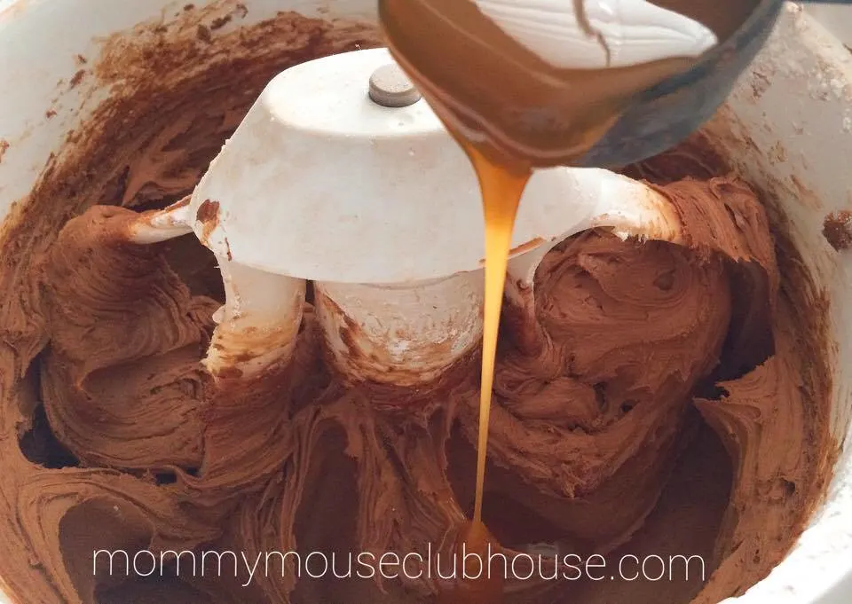 Caramel being added to chocolate frosting to make Chocolate Salted Caramel Cupcakes
