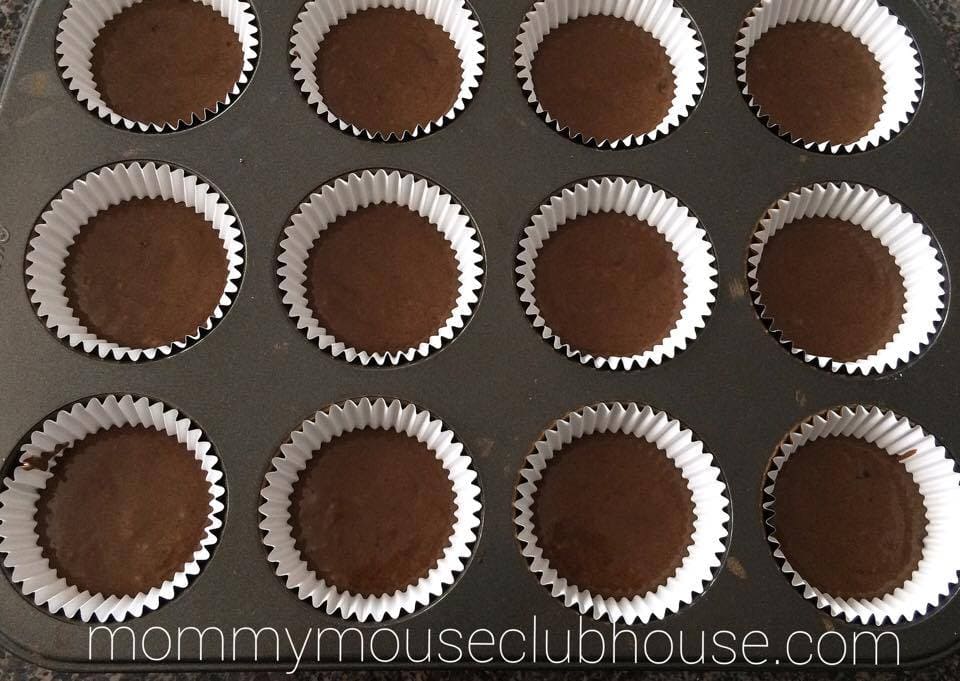 Chocolate Salted Caramel Cupcakes batter in baking cups in a cupcake pan.