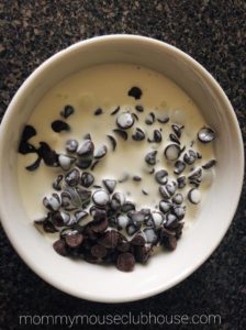 Cream and chocolate chips in a bowl to make Thin Mint Brownies