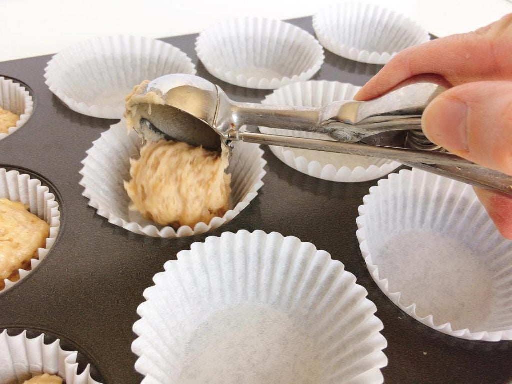 Banana Muffin batter scooped into a pan with a cookie scoop