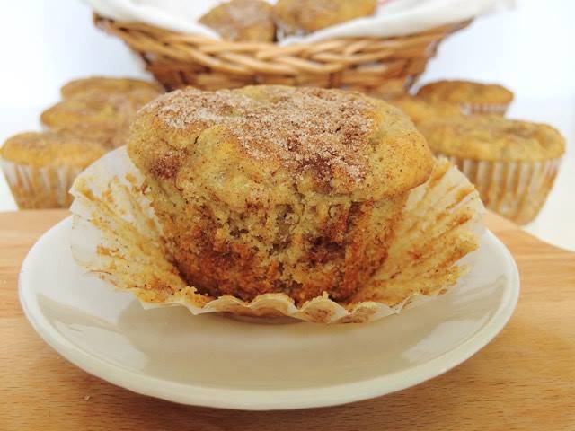 A cinnamon swirl banana muffin on a white plate