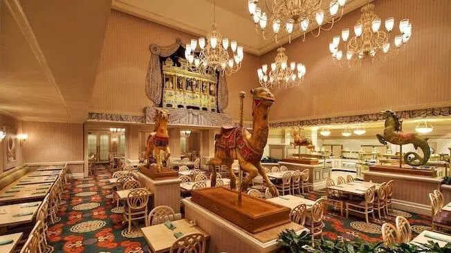 Dining room with tables and chairs, and carousel horses at 1900 Park Fare one of The Best Disney World Character Meals