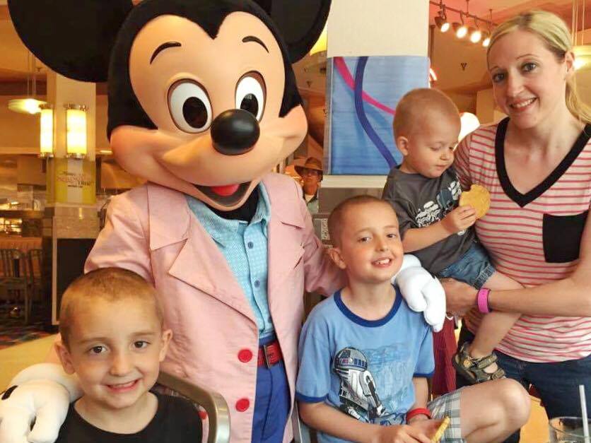 A family at Hollywood and Vine Character meal with Mickey Mouse at Disney World.