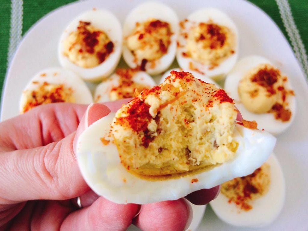 Close up picture of a Crack Deviled Eggs with a bite taken out.