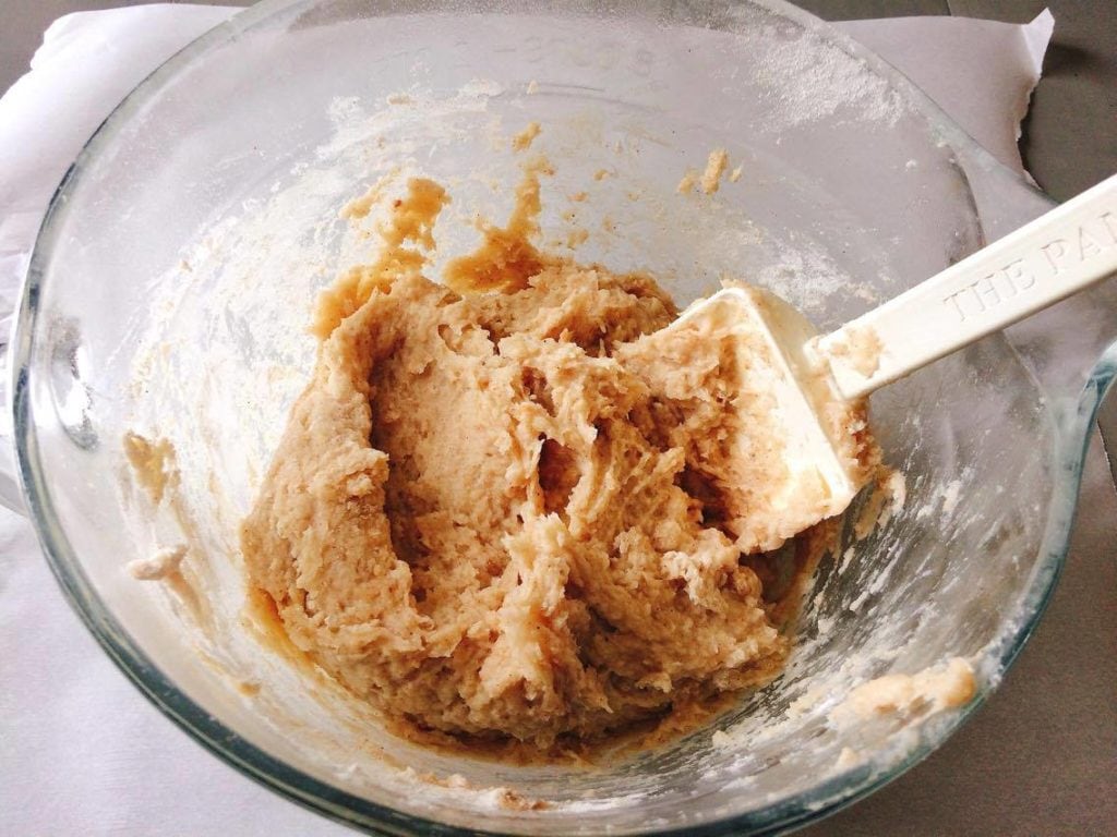 Homemade Disney Churros dough in a glass bowl with a spatula.