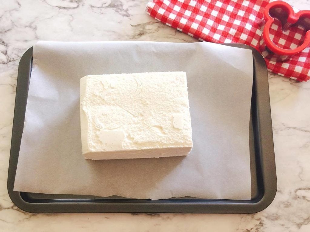 Step 1 A block of ice cream on a baking sheet to make Homemade Hand Dipped Ice Cream Bars