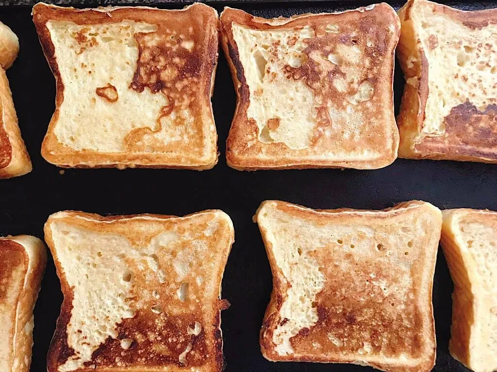 A slice of bread dipped into French Toast Batter