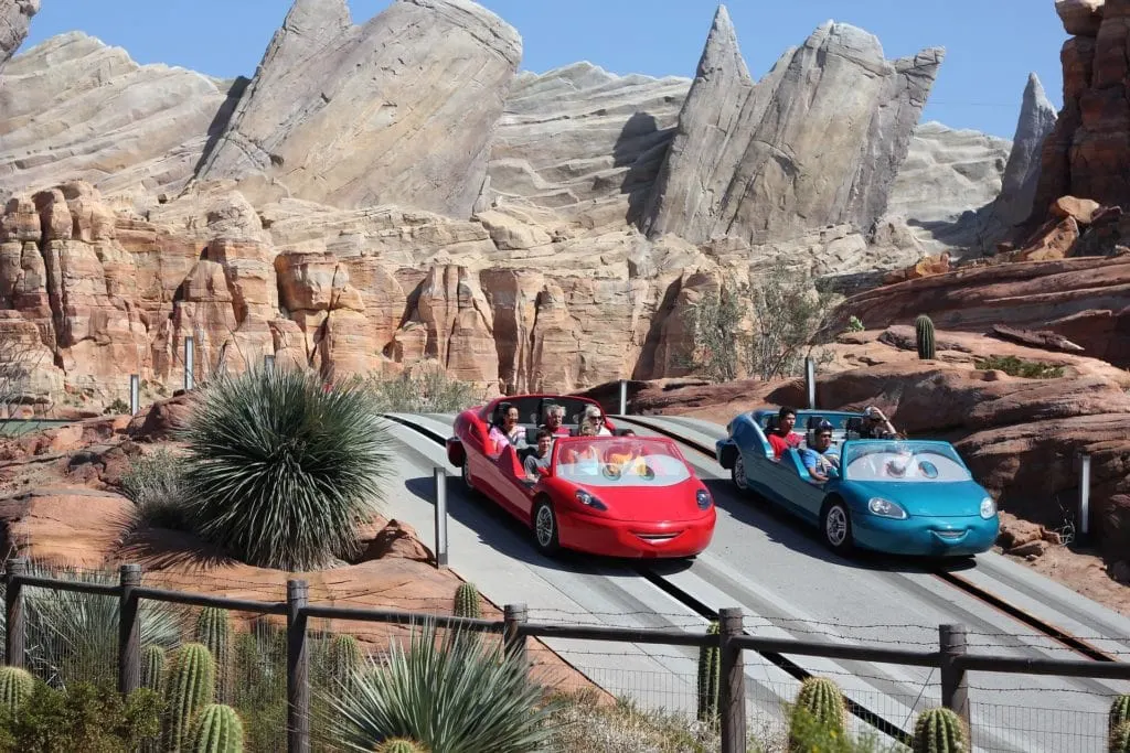 Cars racing on a track at Disneyland using a Park Hopper Ticket