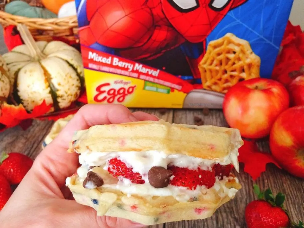 A hand holding a Grilled Sweet Berry Waffle Sandwich