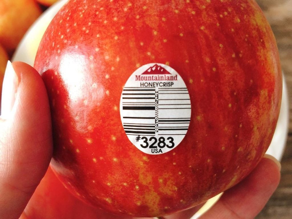 A hand holding a Honeycrisp apple to make Honeycrisp Harvest Salad