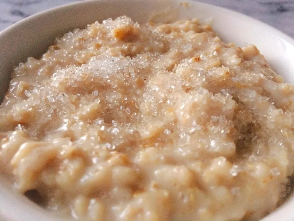 A bowl of oatmeal with sparkling sugar on top