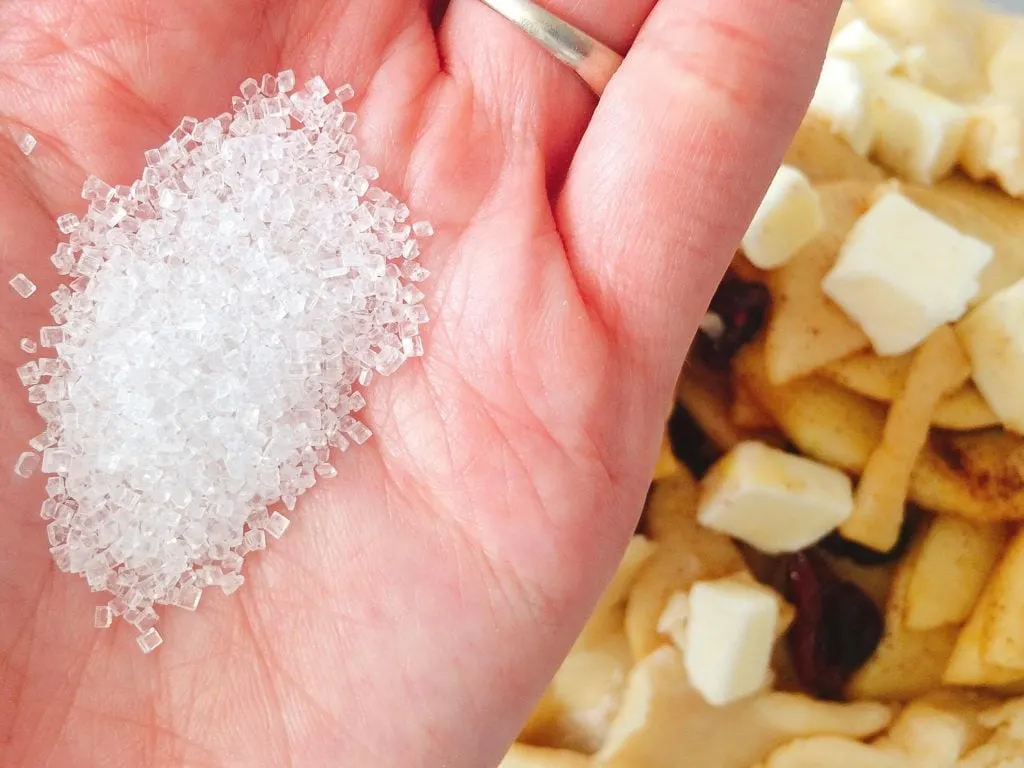 A handful of sparkling sugar over Rustic Apple Pie