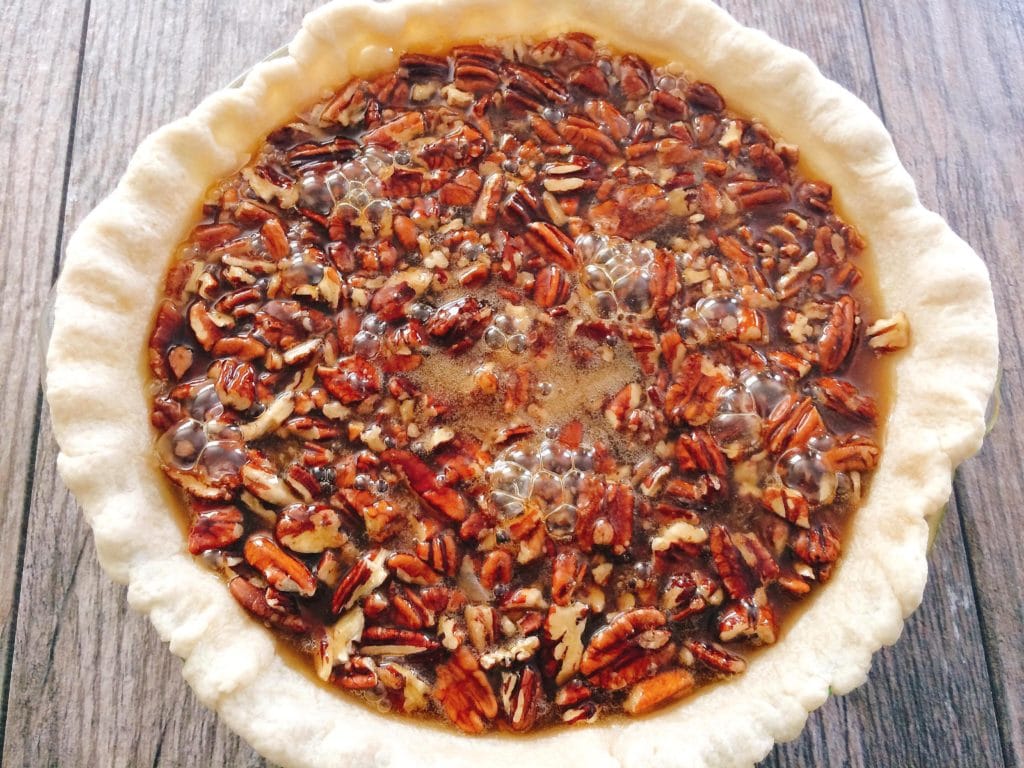 An unbaked Dark Chocolate Pecan Pie