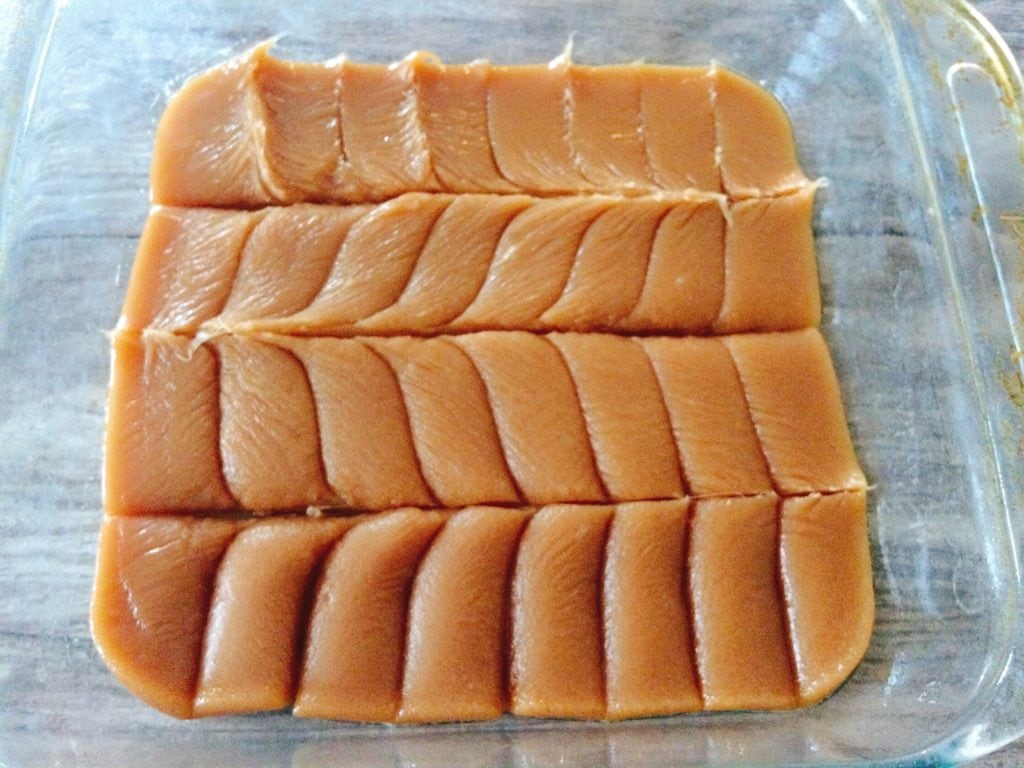 Easy Microwave Soft Caramels cut into rectangles in a dish