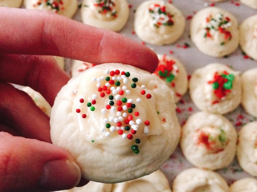 A hand holding Melt-Away Christmas Cookies for a close-up photo