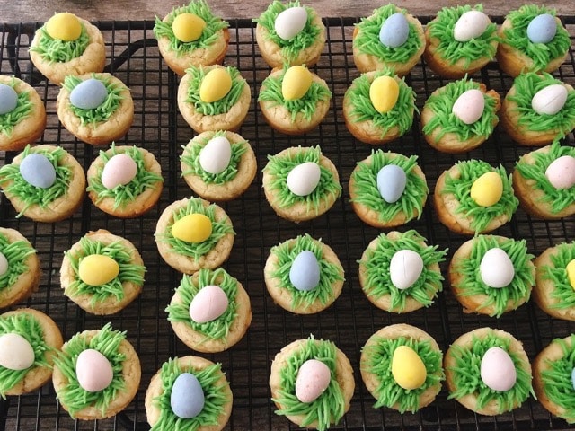 Sugar cookie cups with frosting that looks like grass and a chocolate Easter egg