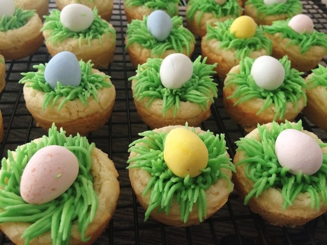 Easter Sugar Cookie Cups with frosting grass and colored chocolate eggs