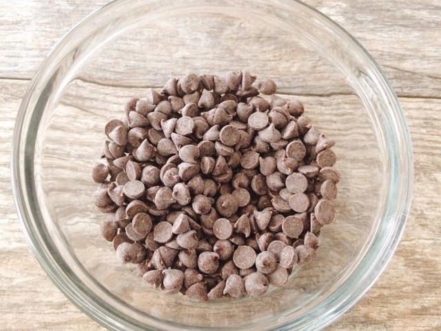 A glass bowl of chocolate chips.