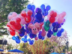 Mickey Mouse Balloons in front of a tree