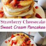A stack Strawberry Cheesecake Pancakes sprinkled with chopped strawberries and layered with Cheesecake Topping on a white plate with a syrup cup and a kitchen towel in the background.