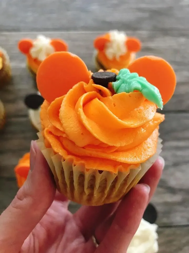 A close up of a Mickey Mouse Pumpkin Halloween Cupcakes.