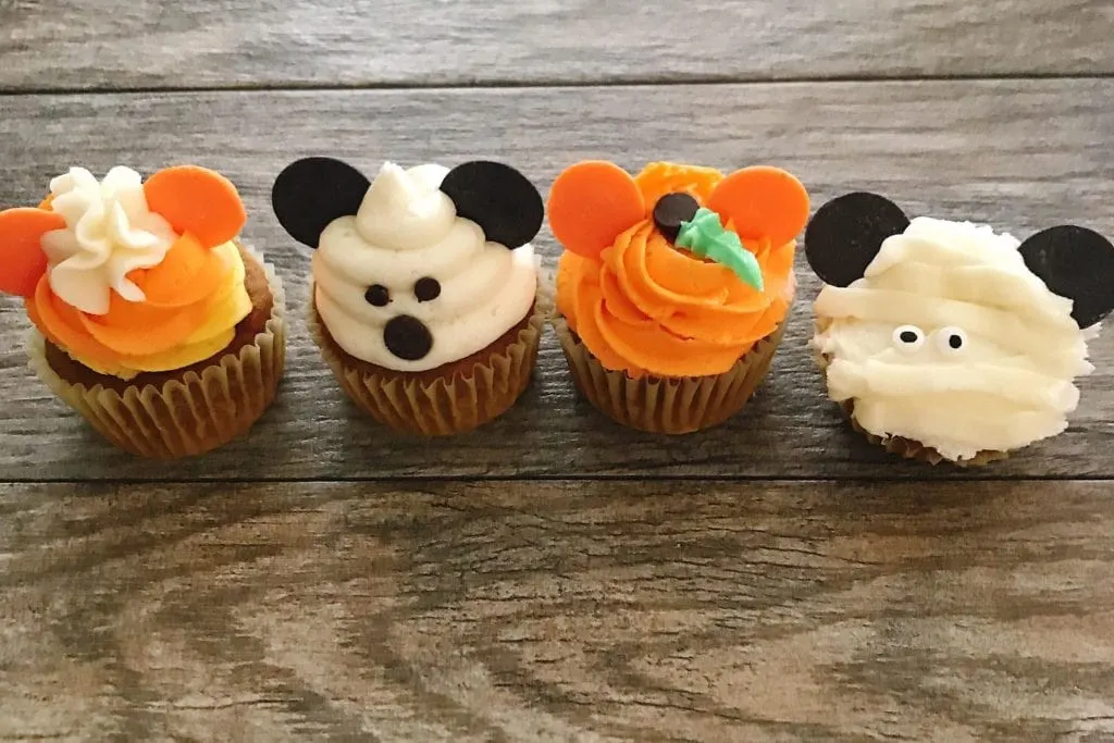Four different Mickey Halloween Cupcakes in a row.