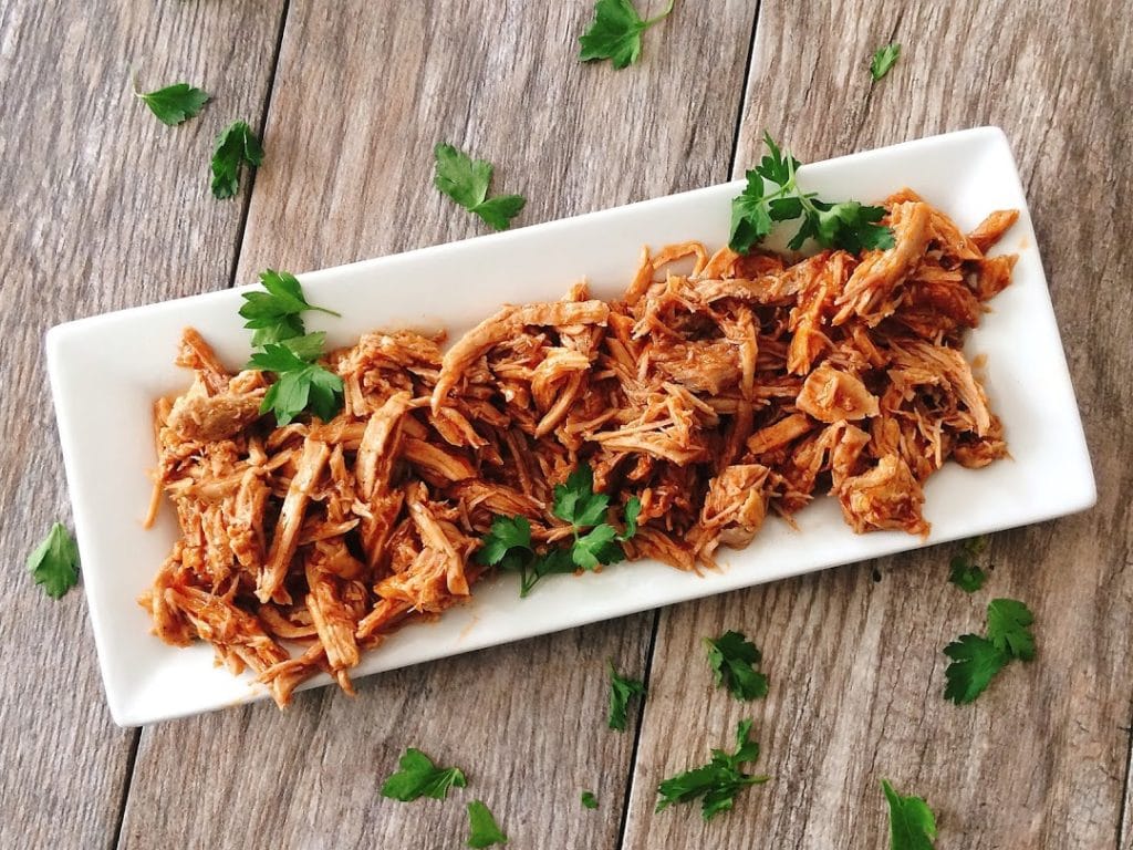 A plate of pulled Sweet Pork Barbacoa like Cafe Rio, sprinkled with cilantro.