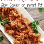 Text "Cafe Rio Sweet Pork Barbacoa Slow Cooker or Instant Pot" over A plate of pulled Sweet Pork Barbacoa like Cafe Rio, sprinkled with cilantro.