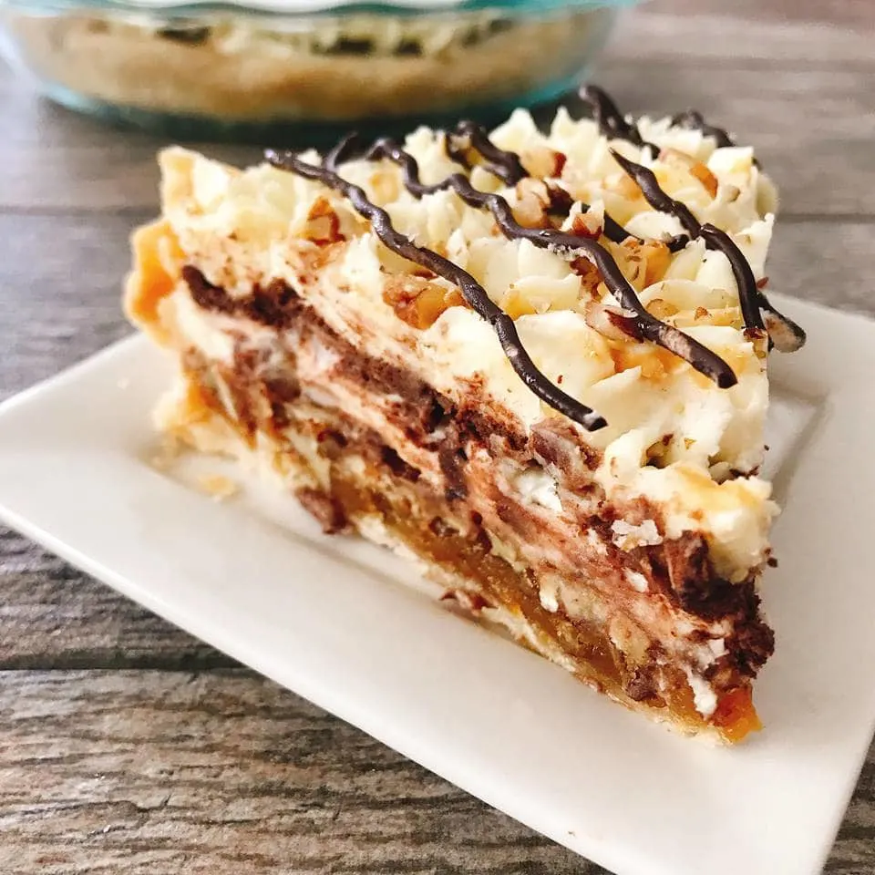 A slice of Caramel Pecan Silk Pie on a white plate.