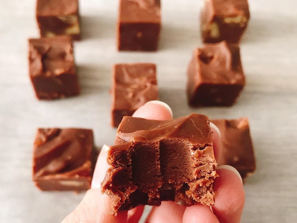 A piece of easy homemade fudge recipe with a bite taken out.