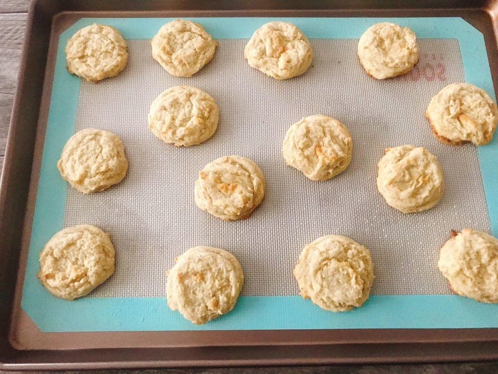 A top view of freshly baked Frosted Eggnog Cookie Dough lined up on a baking sheet.