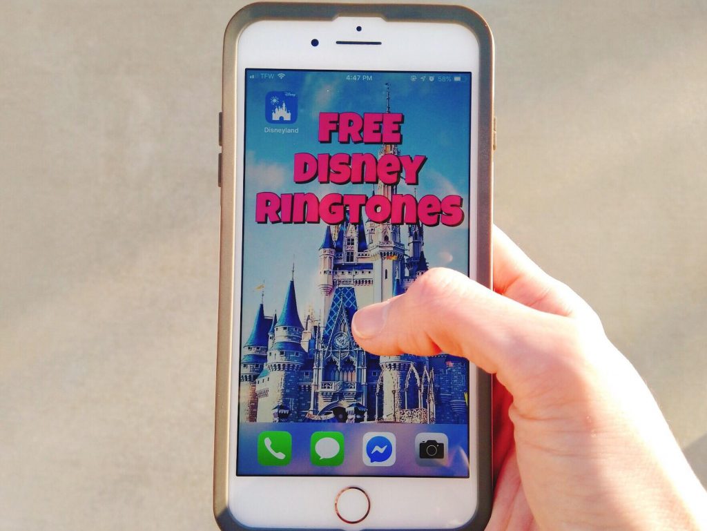 A hand holding an phone with a picture of Cinderella's castle and the words "Free Disney Ringtones".