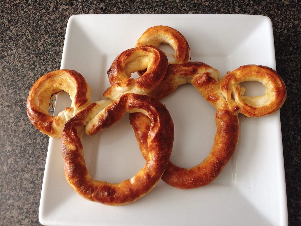 Two Mickey Pretzels on a white plate. 