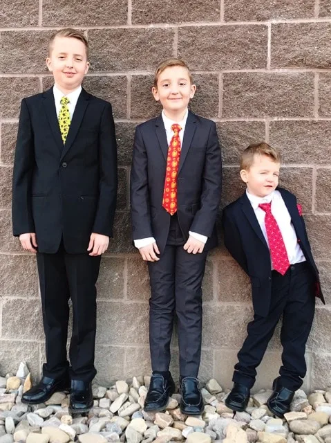 Three boys dressed in super hero themed suits.