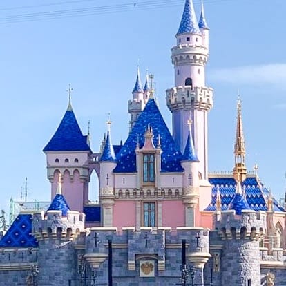 Sleeping Beauty Castle at Disneyland with a blue roof.