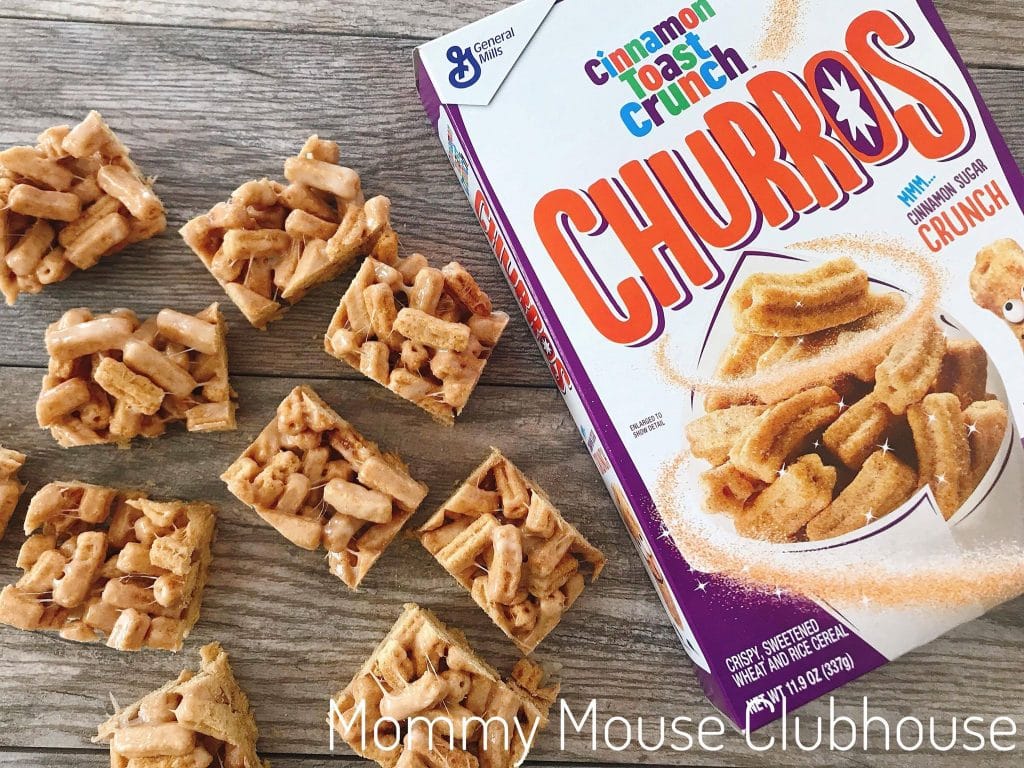 Churro Cereal Treats cut into squares next to a box of Cinnamon Toast Crunch Churros.