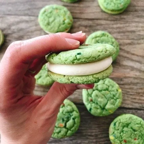 A hand holding a shamrock shake cookie