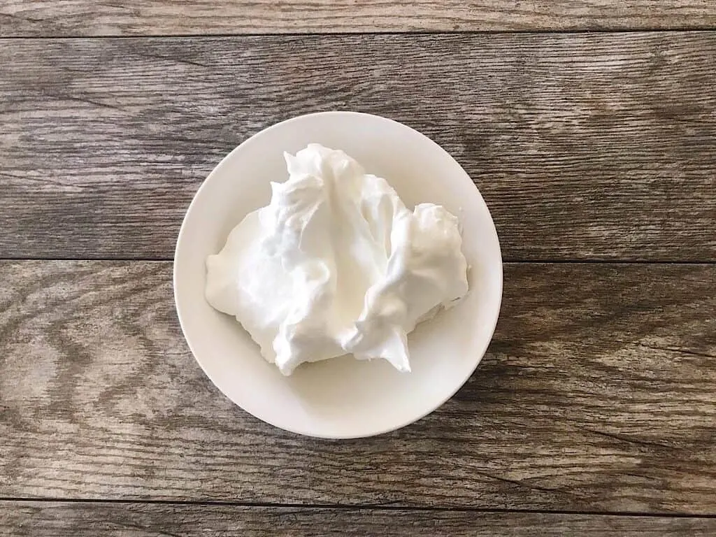 Whipped Egg whites in a bowl.