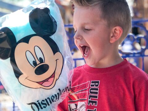 A boy excited to eat Mickey Mouse Cotton Candy at Disneyland