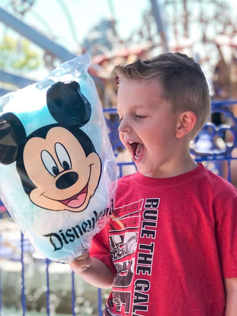 A boy excited to eat Mickey Mouse Cotton Candy at Disneyland