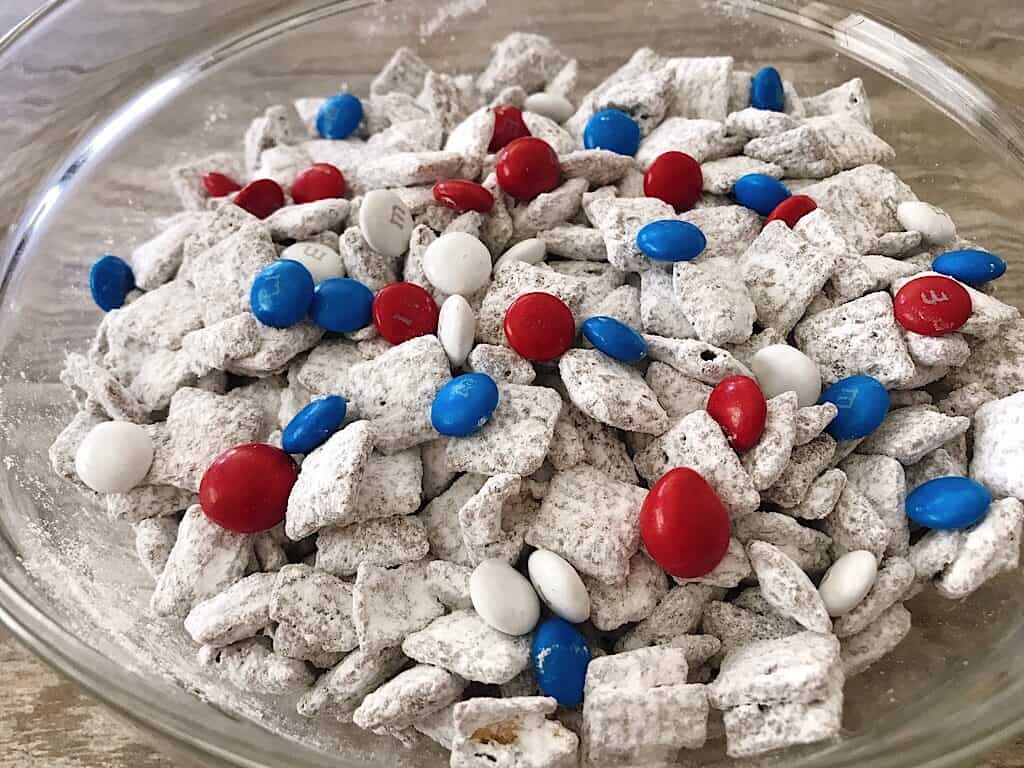 A bowl of Muddy Buddies with Red, White, and Blue M&M’s for the 4th of July.