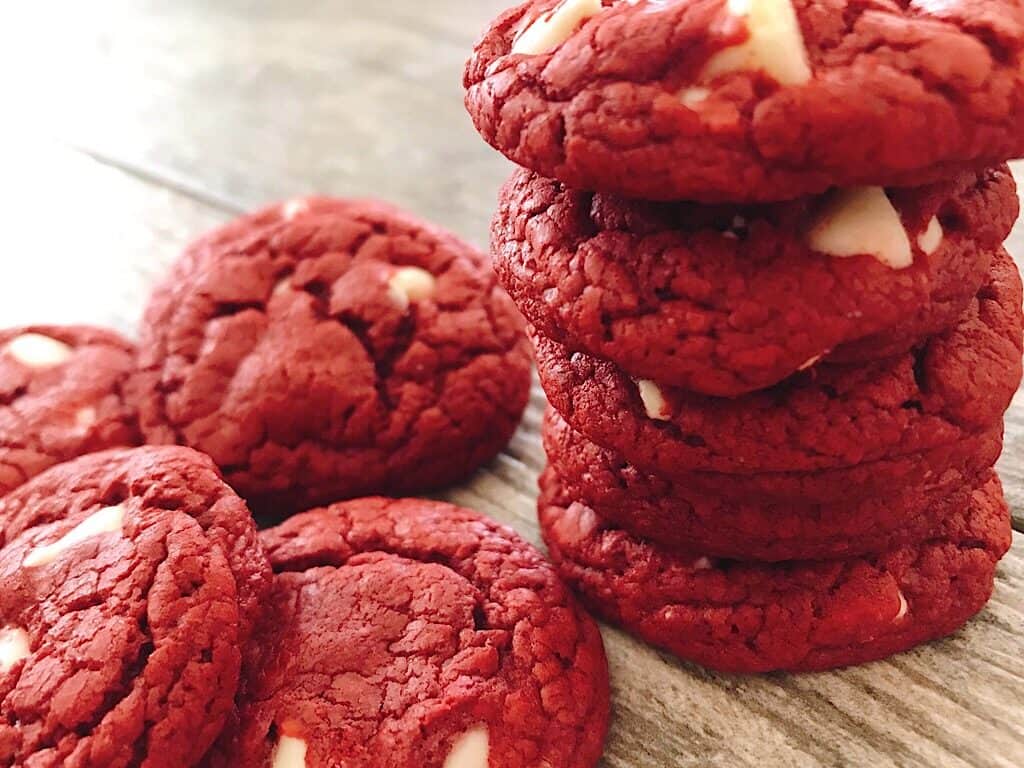 A stack of red velvet cookies with white chocolate chips.