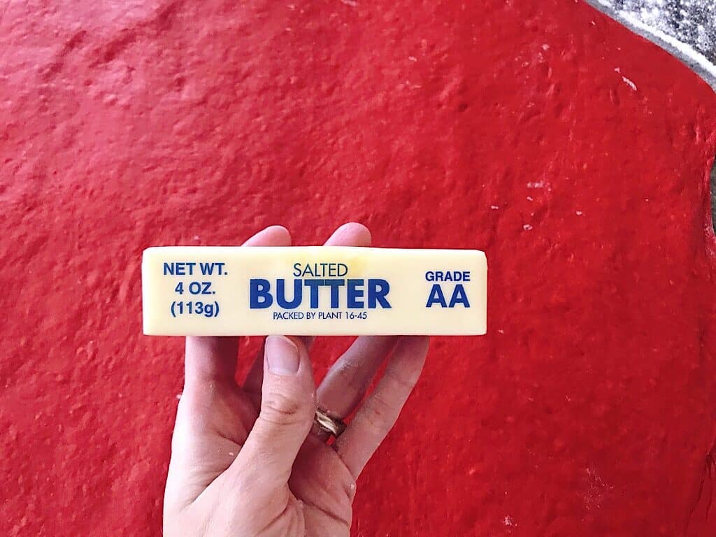 A stick of butter and red velvet dough